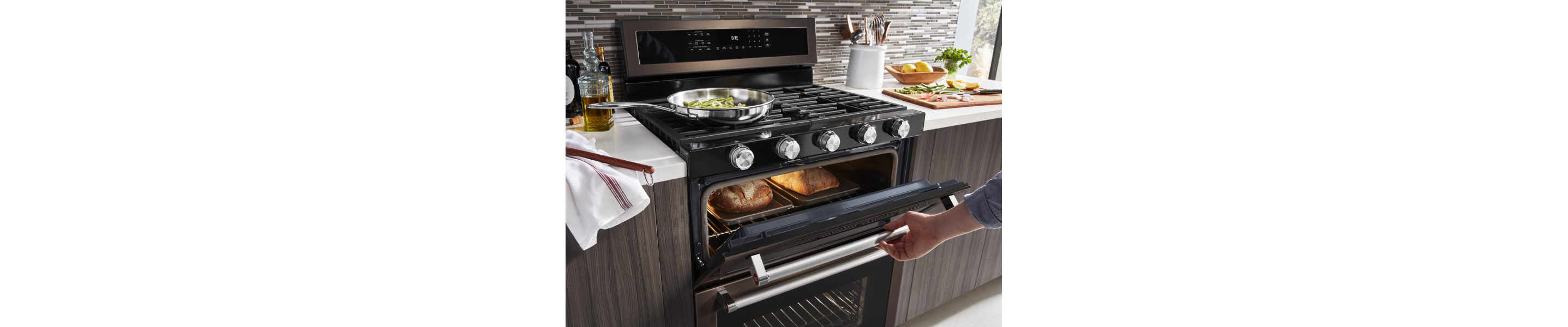 Woman cooking in gas oven