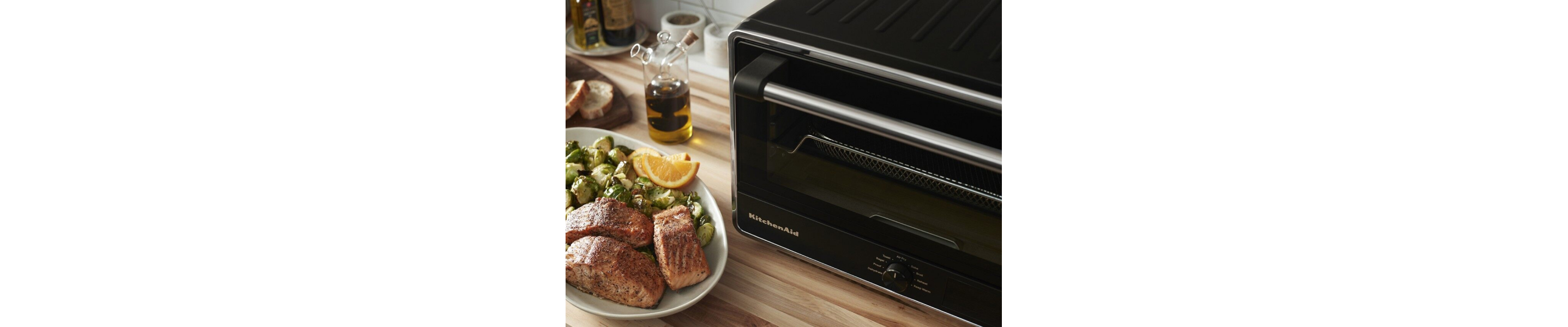 KitchenAid® countertop oven and tray of salmon and Brussels sprouts