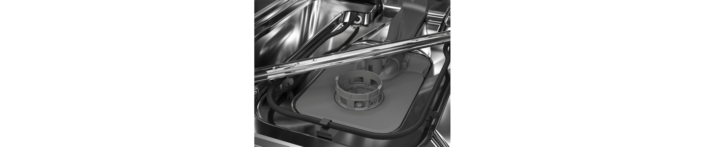 A closeup of a spray arm at the base of a KitchenAid® dishwasher.