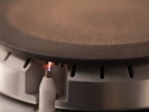 A closeup of an igniter on a gas stovetop