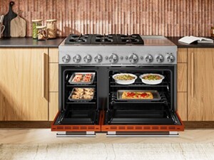 A commercial style double oven gas range with the doors open and food inside