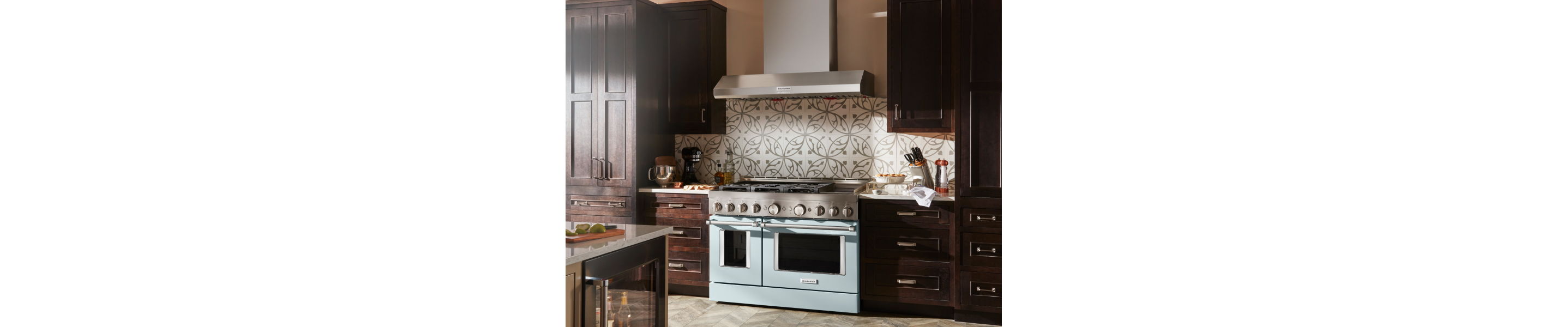 KitchenAid® wall mount range hood above decorative backsplash and range
