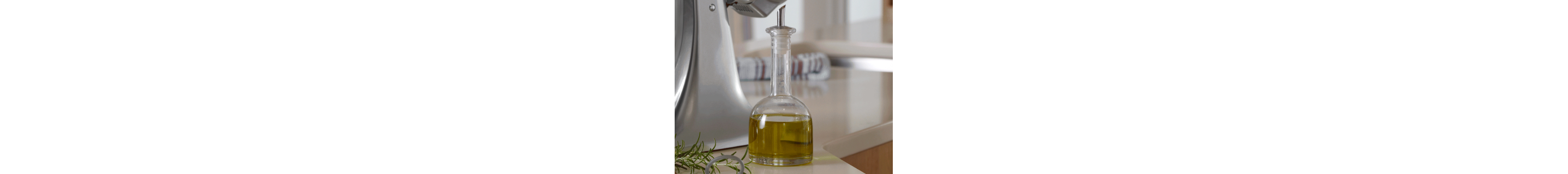 Glass bottle of oil on a counter 