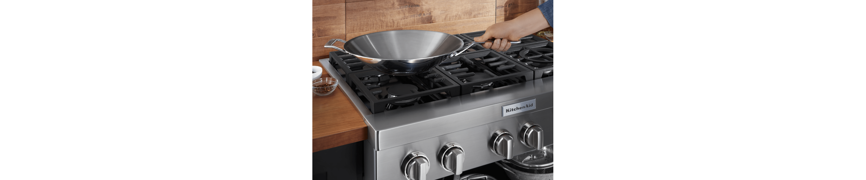 Person holding handle of pan