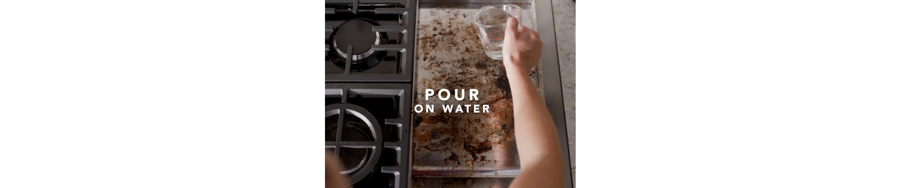 Person pouring water on dirty griddle 