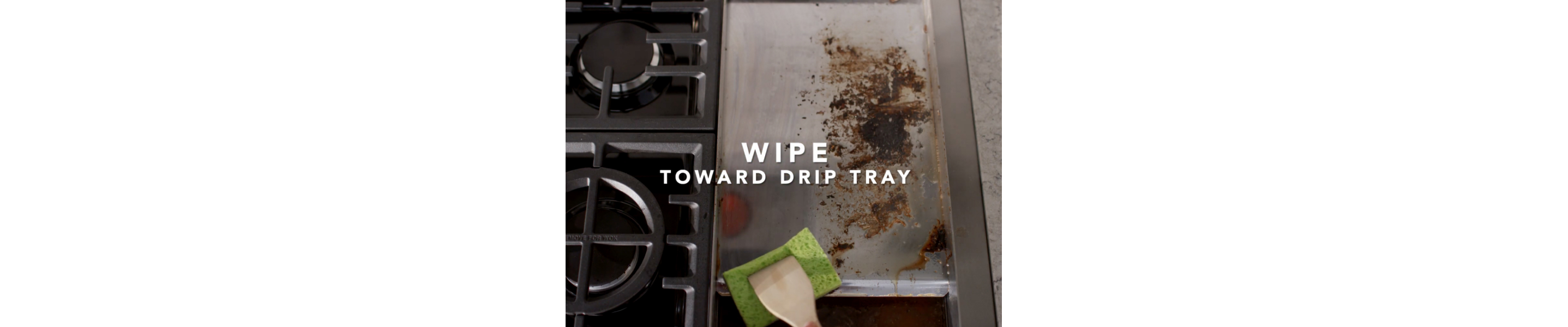 Scrubbing dirty griddle with sponge and wooden spoon