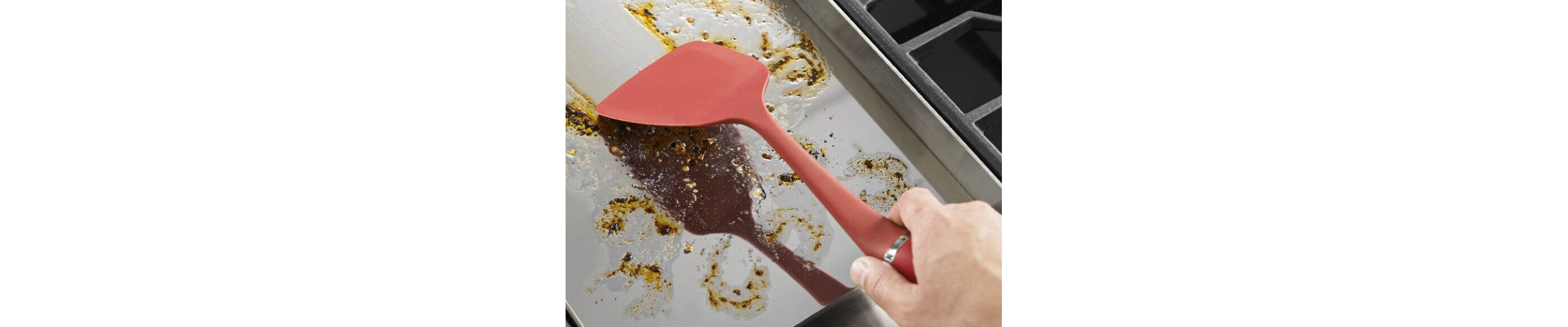 Spatula cleaning a baking sheet