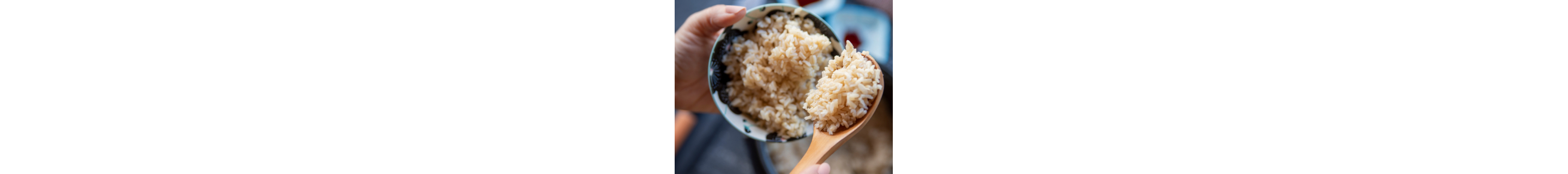 Person scooping rice into a bowl