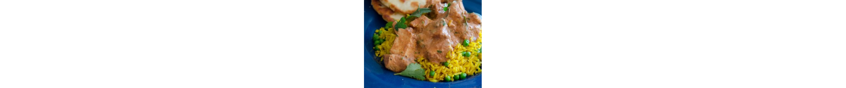 A plate of seasoned rice with beef covered with a sauce.