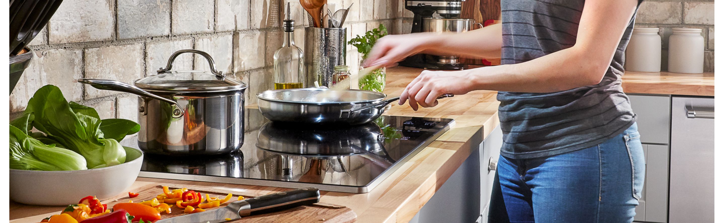 Person cooking on a glass surface cooktop