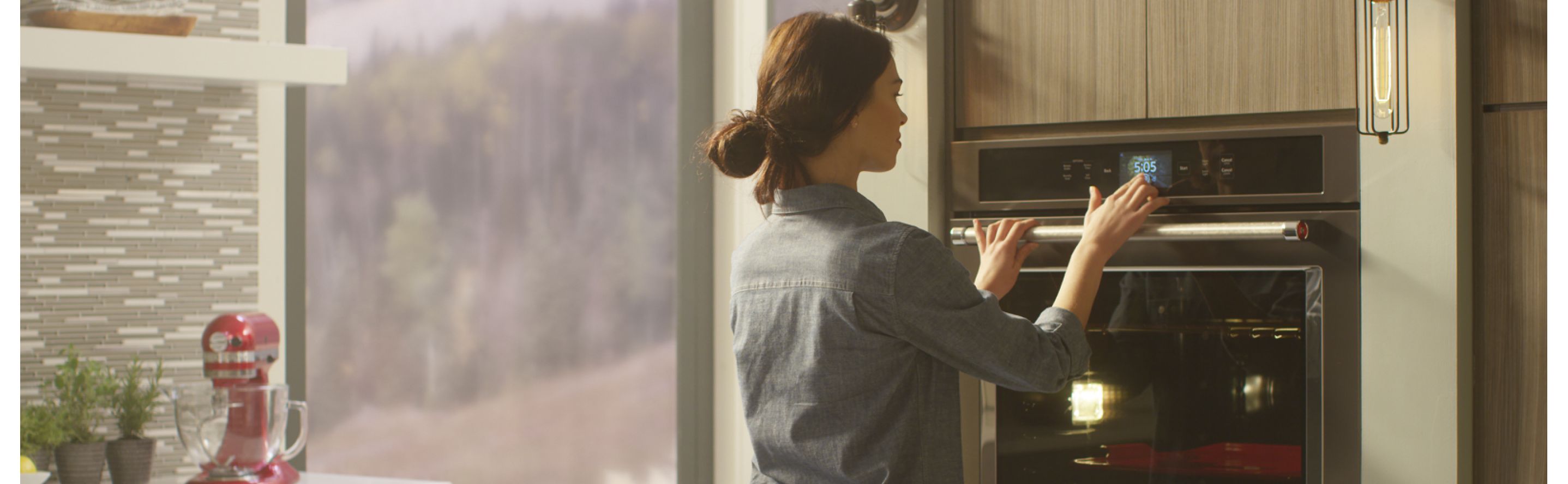 Person selecting settings on KitchenAid® wall oven