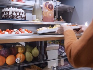 Someone putting a platter of food in their refrigerator