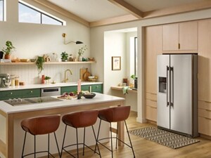 A bright kitchen with green cabinets and KitchenAid® Appliances