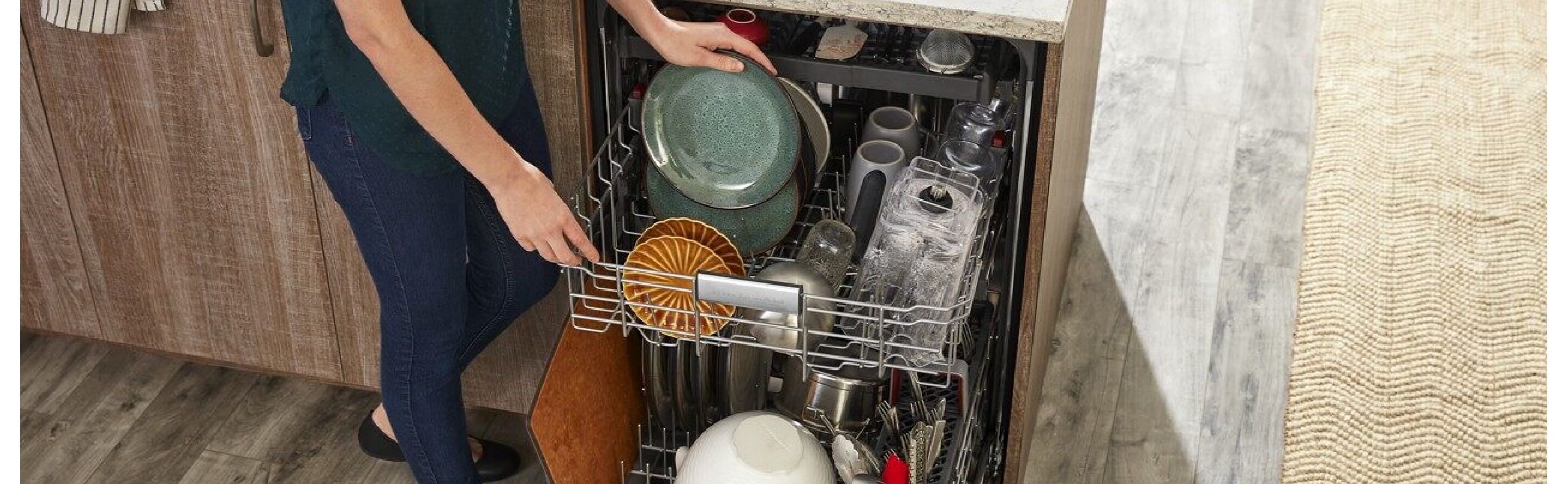 Person loading dishes into dishwasher
