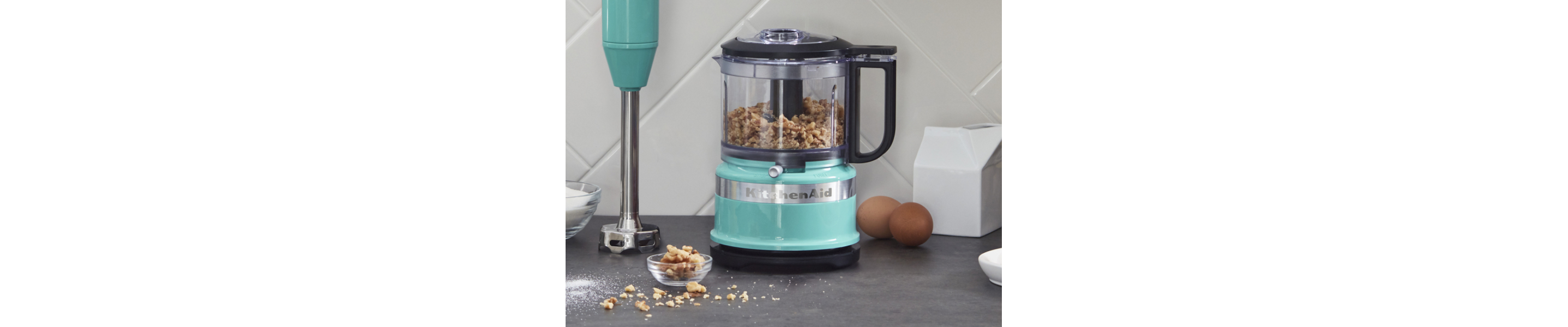 Walnuts inside a teal KitchenAid® food chopper