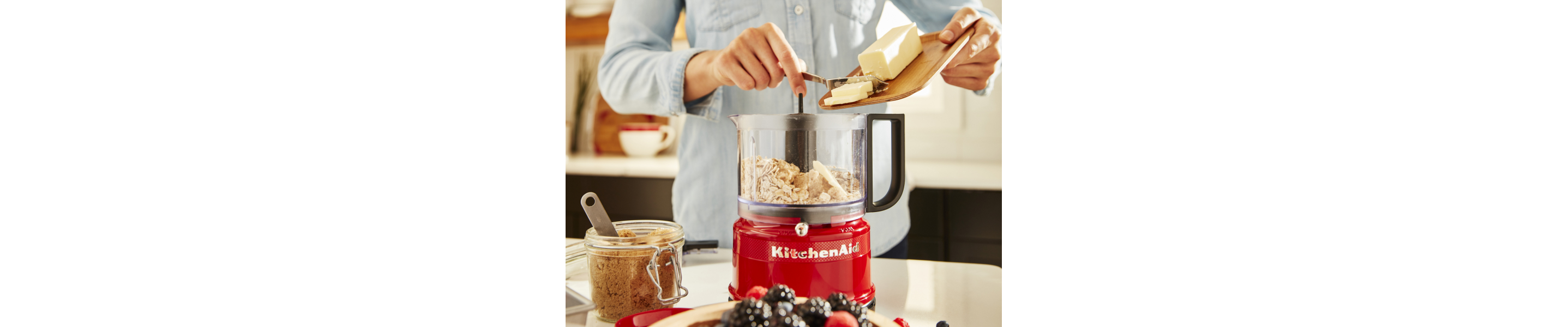 Person adding butter to a KitchenAid® food processor