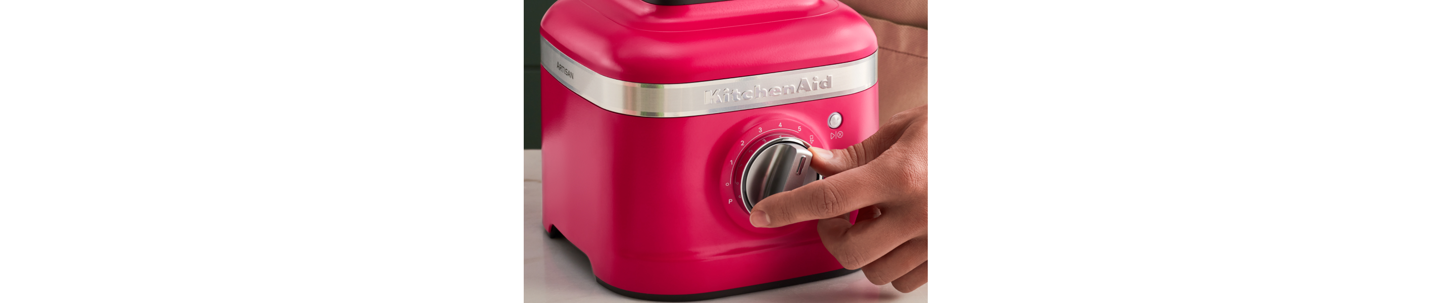 Person turning a knob on a KitchenAid® blender