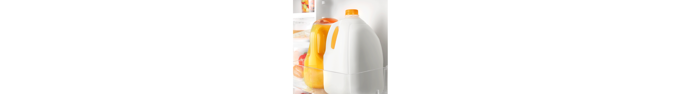 Milk and orange juice inside a refrigerator