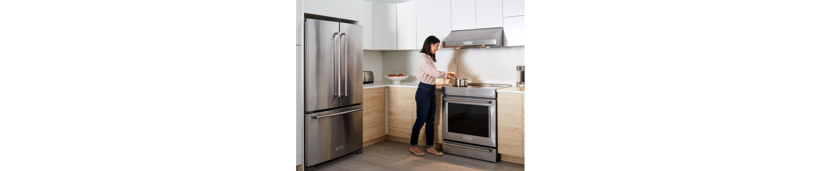 A person boiling water on an oven