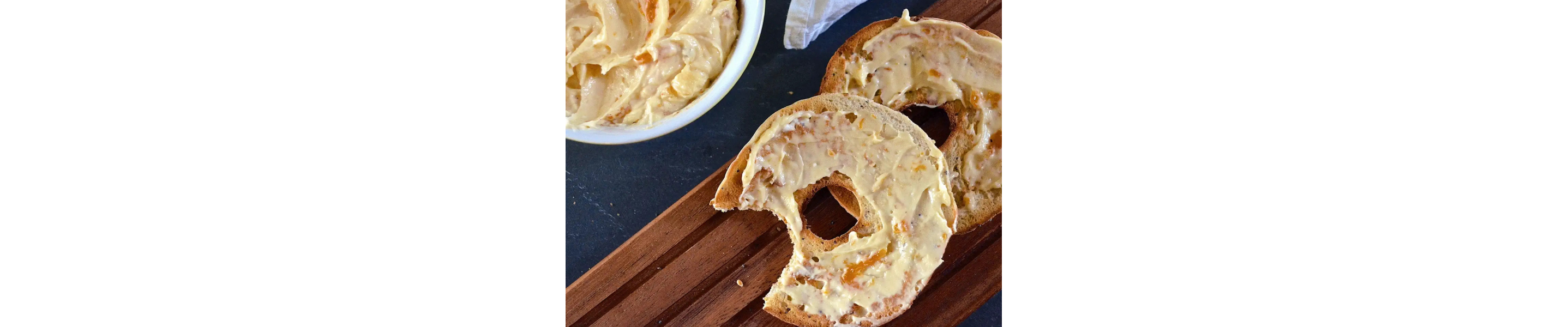 Apricot cheese spread on a bagel