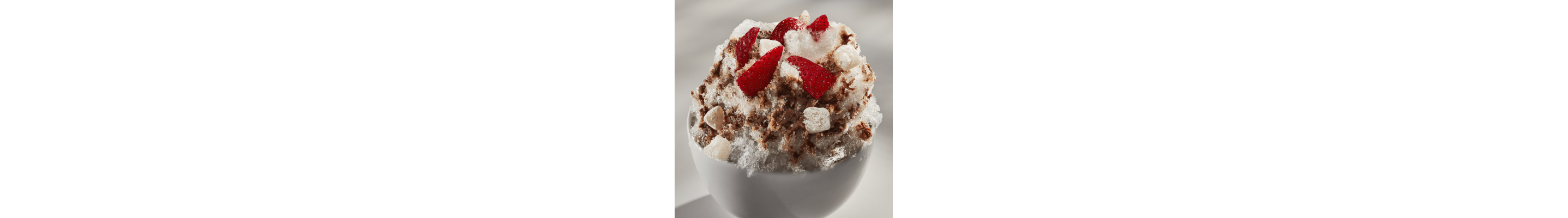 Shaved ice dessert with chopped fruit, nuts and tteok