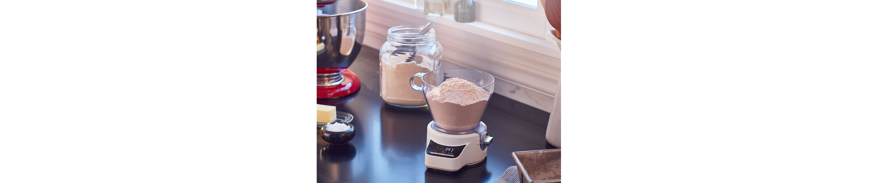 Flour sitting in a food scale on a black countertop 