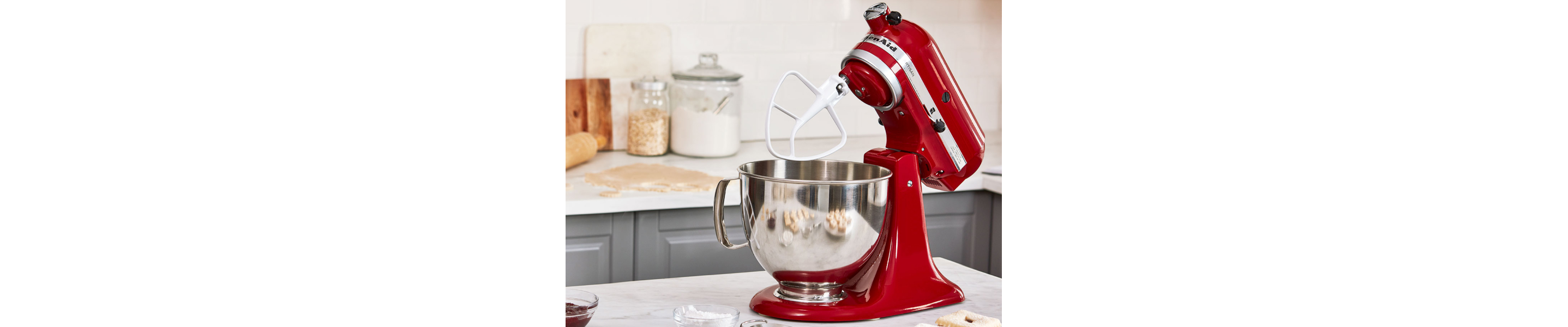 Red KitchenAid® tilt-head stand mixer with the KitchenAid® Flat Beater accessory attached