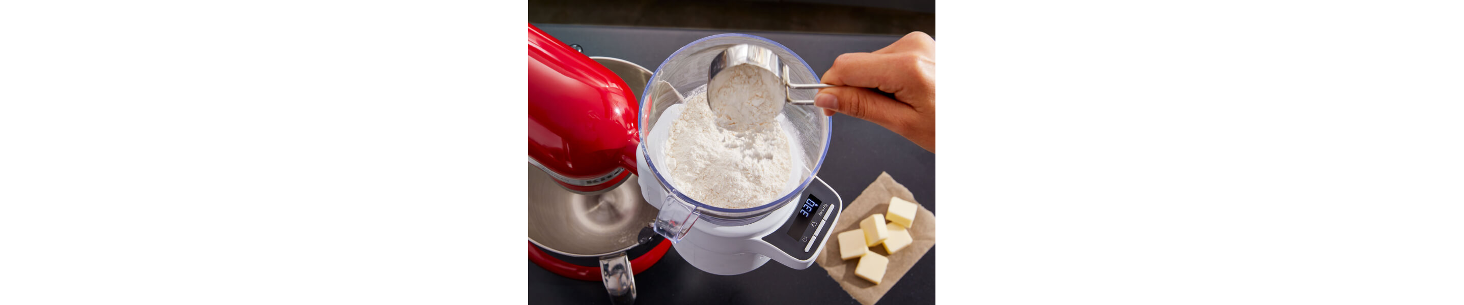 Person adding flour to the KitchenAid® Sifter + Scale Attachment