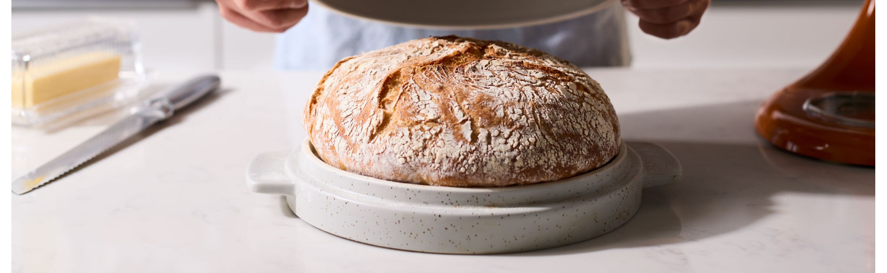 Fresh loaf of bread on a KitchenAid® Bread Bowl Lid