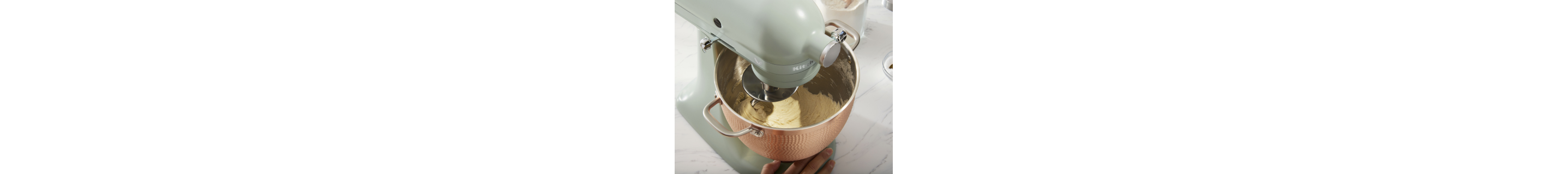 KitchenAid® stand mixer with dough hook mixing dough