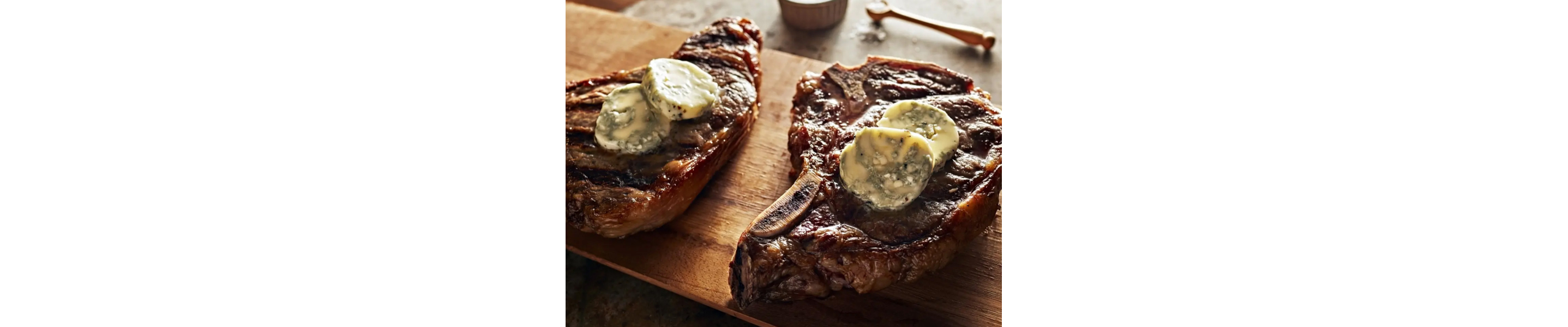 Ribeye steaks with blue cheese butter on top