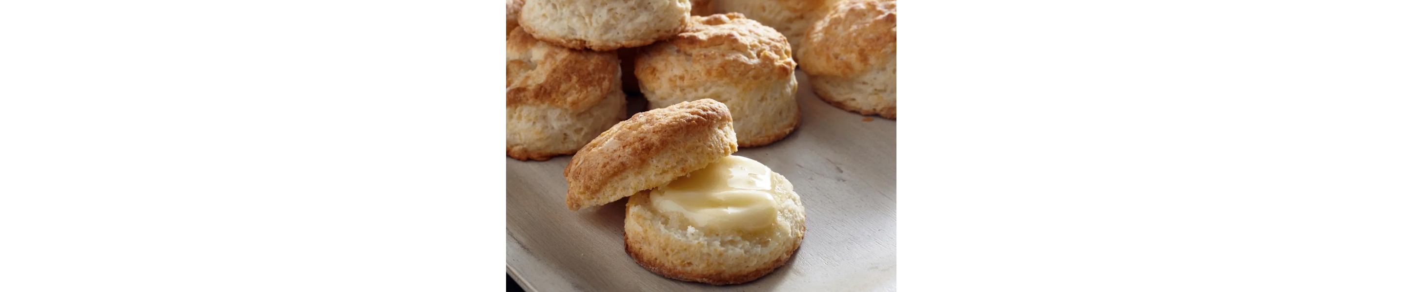 Cut biscuit with pat of butter on it