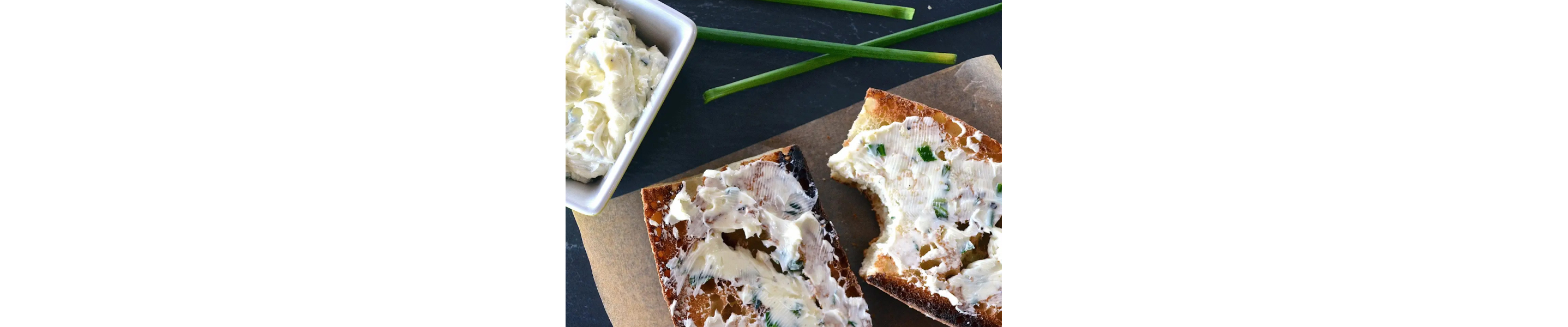 Toasted baguette with herb butter spread on it
