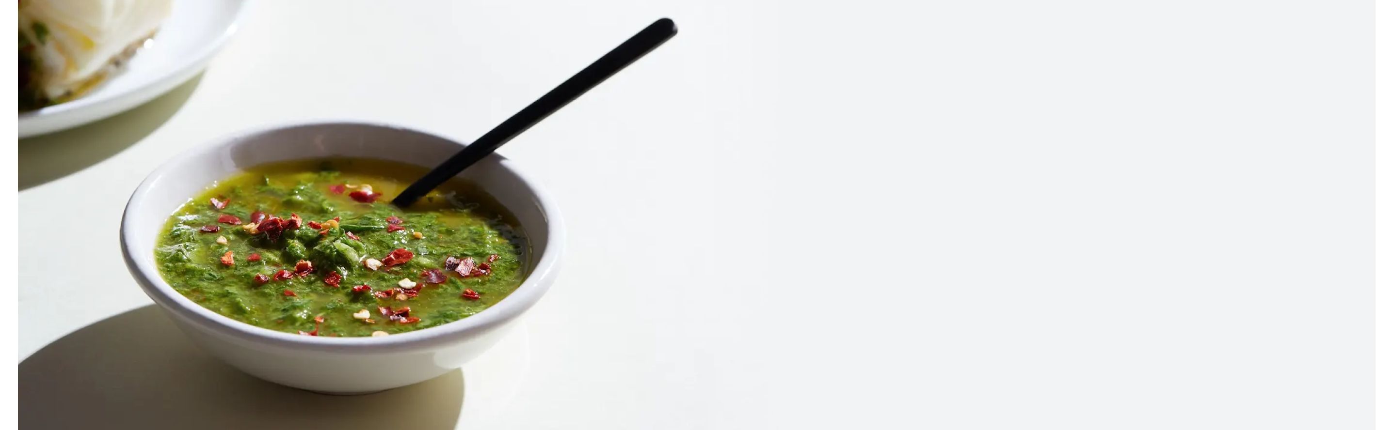 White bowl filled with chimichurri