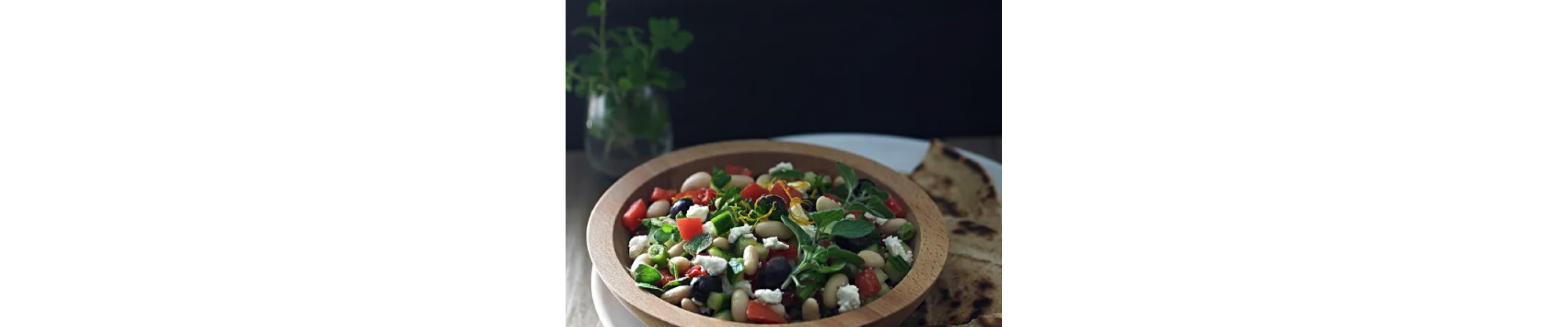 A closeup of a Mediterranean white bean salad.