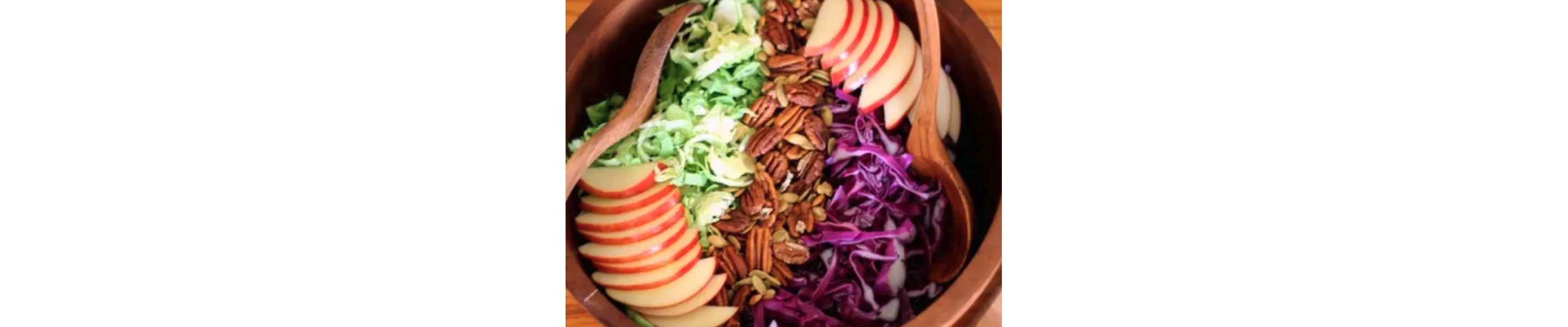 A closeup of a Brussels slaw salad with maple tahini dressing.