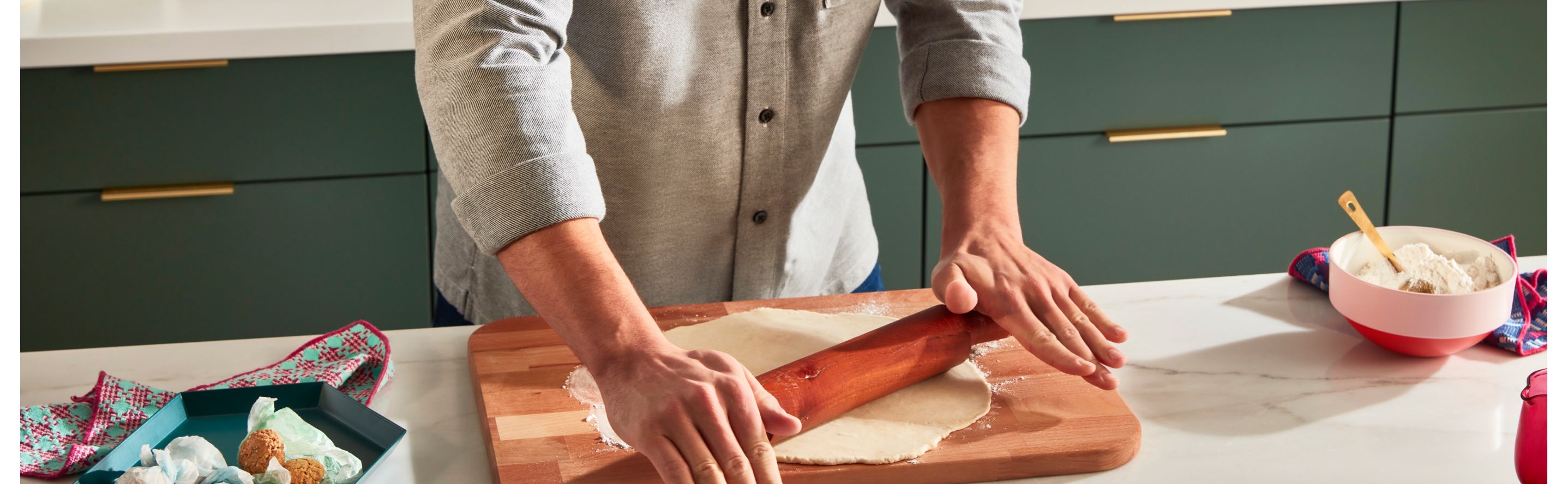 Person rolling out dough with a rolling pin