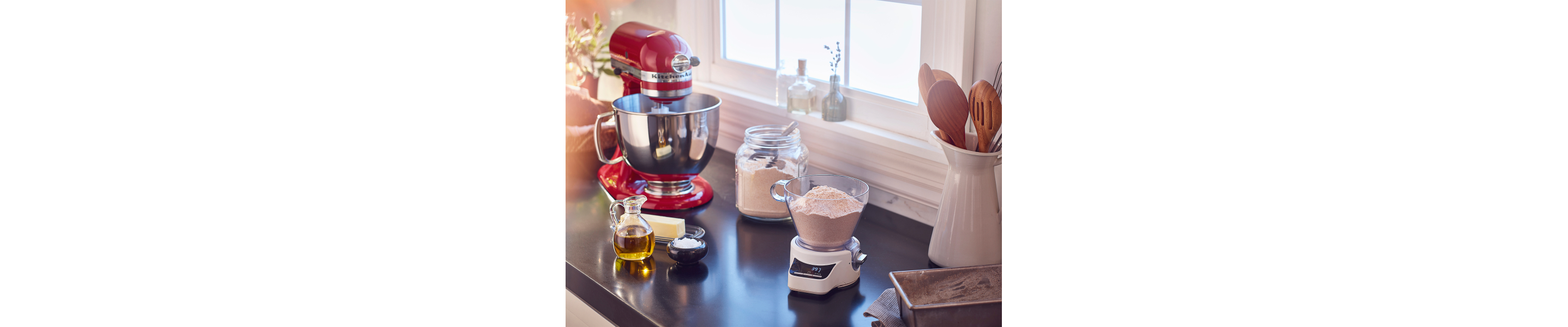 Red KitchenAid® stand mixer next to a food scale with flour