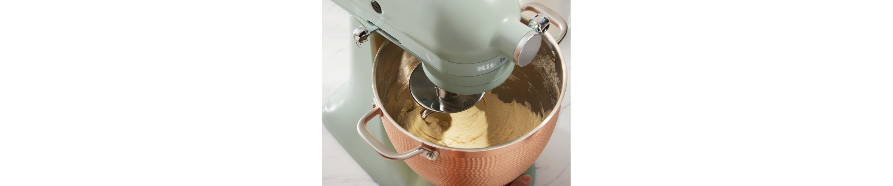 Blue KitchenAid® stand mixer mixing dough