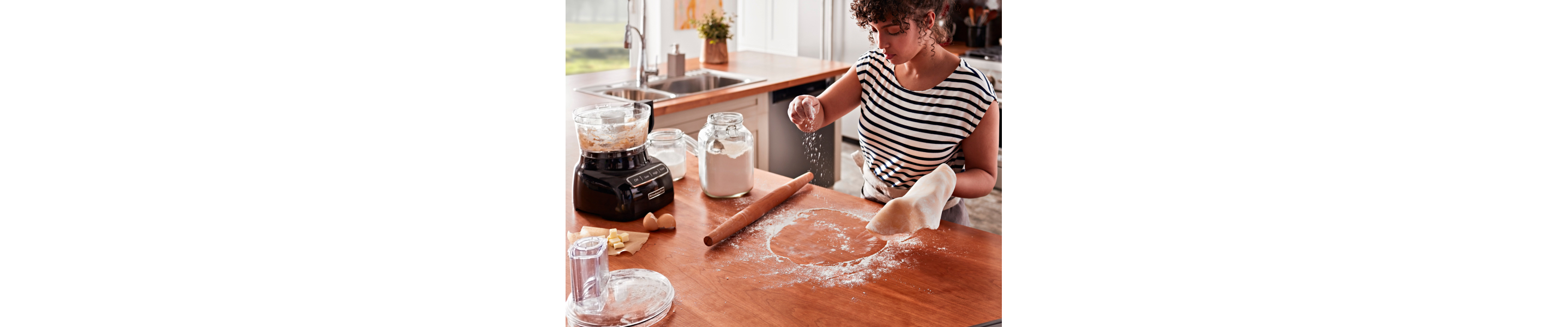 Person dusting flour on a rolling surface
