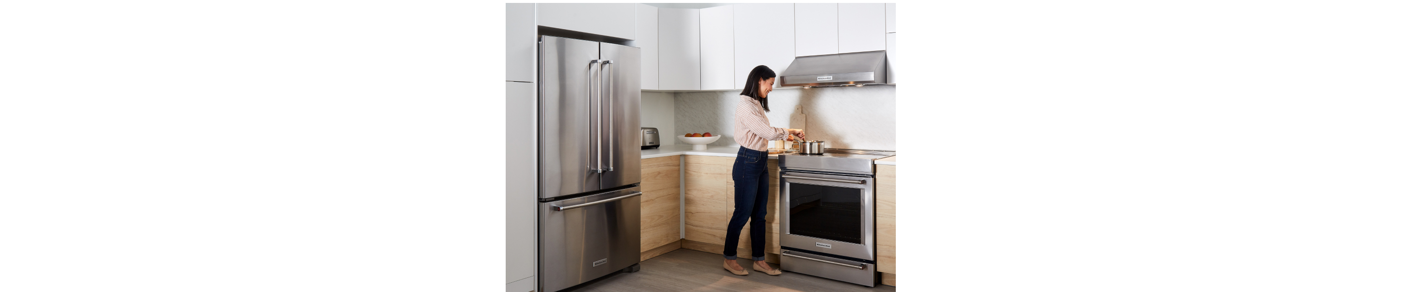Person cooking on a stainless steel range