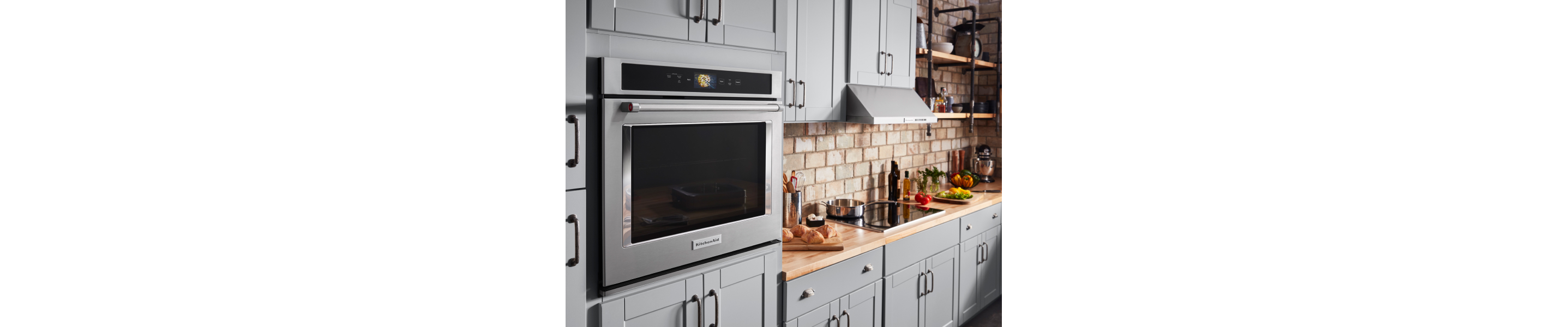 Stainless steel KitchenAid® wall oven in a rustic kitchen