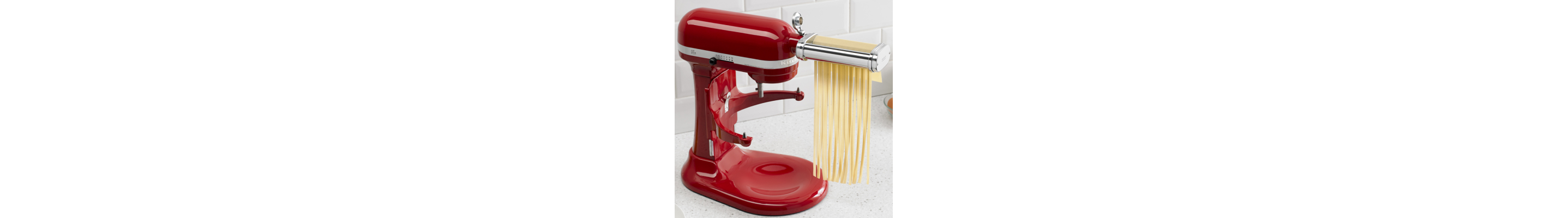 KitchenAid® Pasta Cutter Attachment cutting pasta dough into thick noodles