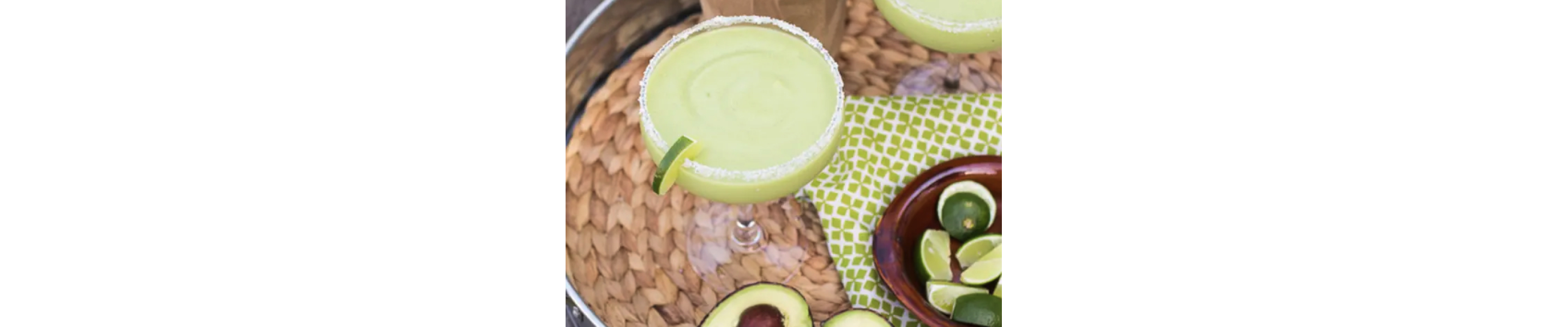 Frozen avocado margaritas with lime garnish