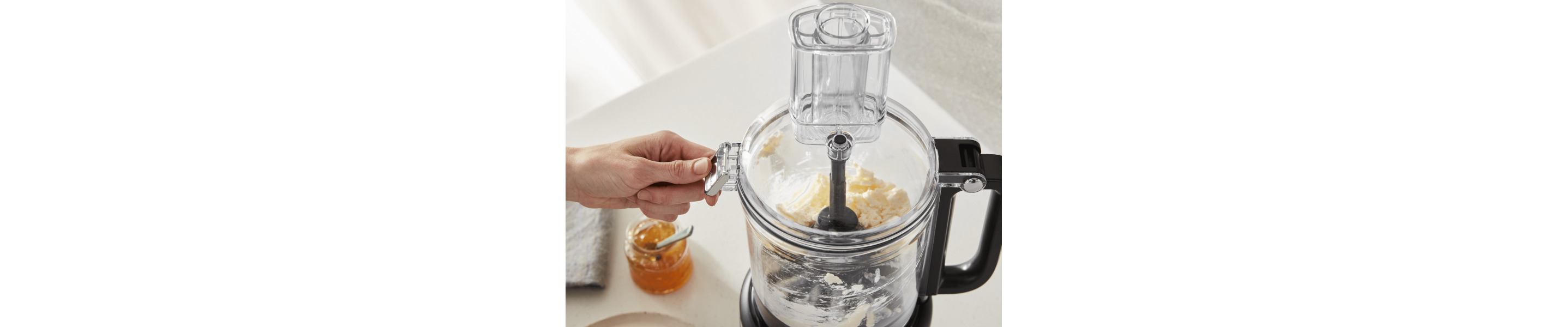  Person using food processor to process ingredients