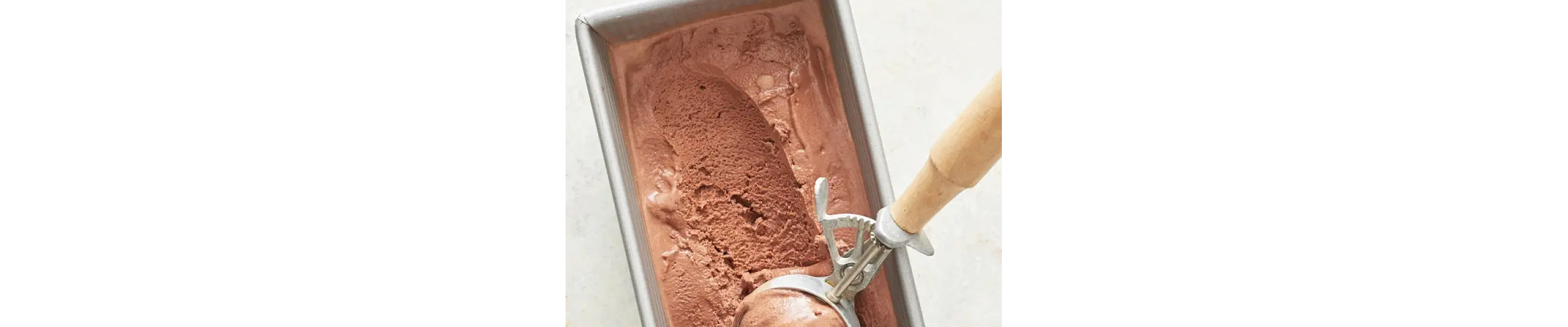 Chocolate ice cream in a freezer safe container.