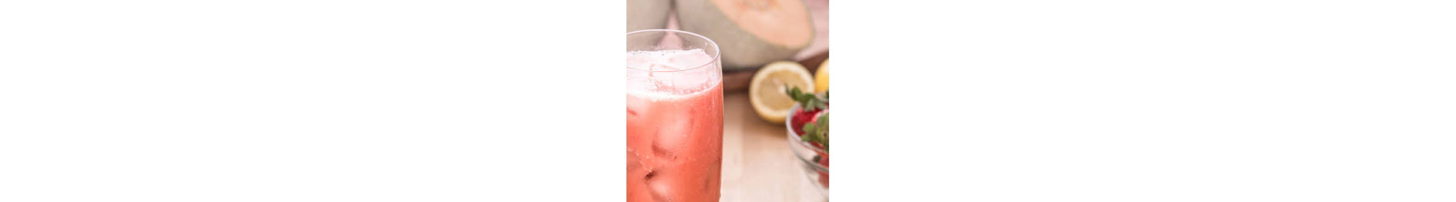 Blended strawberry juice in a glass with ice