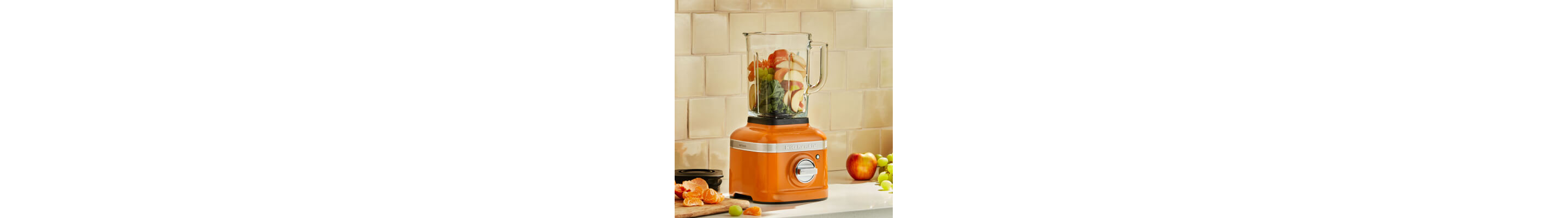 Fruits and vegetables in an orange KitchenAid® blender