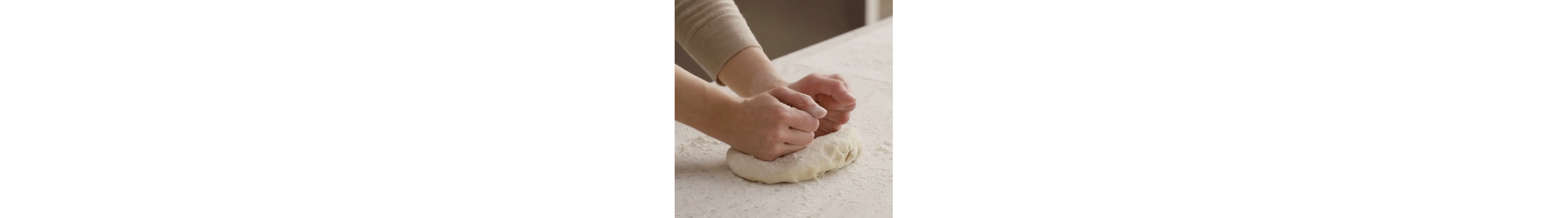 Hands stretching out dough