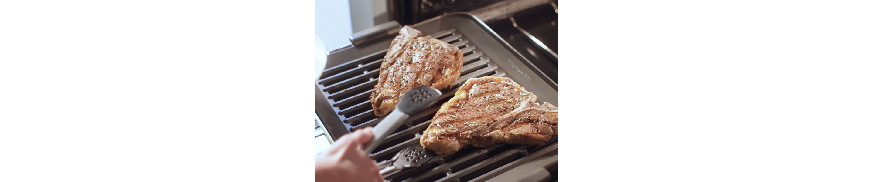 Two pork loins searing on a KitchenAid® Smart Oven+ Grill Attachment